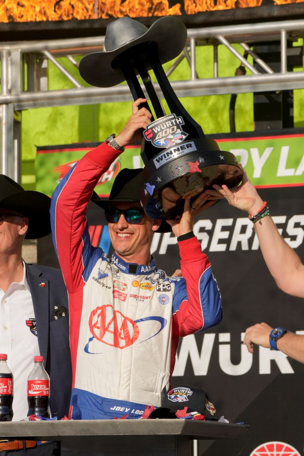Joey Logano holds the Wurth 400 trophy in Victory Lane...