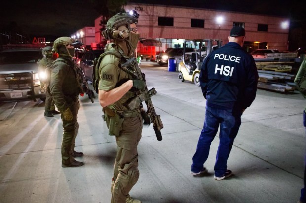 ICE agents of its Homeland Security Investigations division stood at the entrance of San Diego Powder & Protective Coatings, a business in the City of El Cajon where dozens of ICE and DEA agents descended to conduct an immigration raid on March 27, 2025. They detained at least 16 employees, though in the process, all workers were held in zip ties and marked with a sharpie to indicate the building where they worked. Family remembers and coworkers remained outside waiting to learn what would happen of those detained.