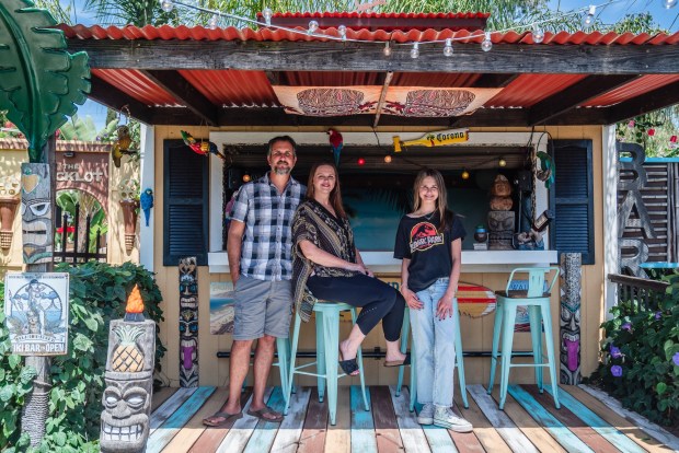 Jared, Tiffany and their daughter Madison at their tiki-inspired outdoor bar in Lakeside. (Ariana Drehsler / For The San Diego Union-Tribune)