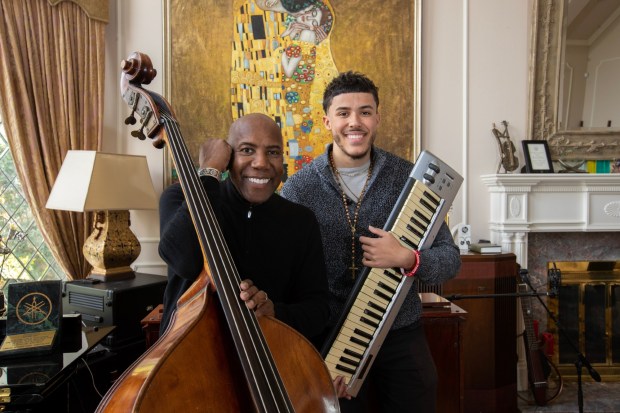Bassist Nathan East, left, is making an album with his son, singer-keyboardist Noah East, right. Photographed in their home on Thursday, Feb. 16, 2023 in Tarzana, CA. (Brian van der Brug / Los Angeles Times)
