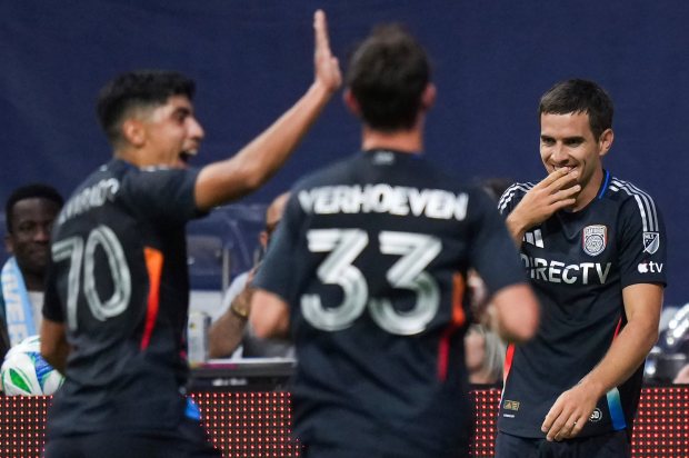 San Diego FC's Milan Iloski, back right, celebrates his second goal against the Vancouver Whitecaps with Alejandro Alvarado Jr. (70) and Oscar Verhoeven (33) during the first half of an MLS soccer match in Vancouver, British Columbia, Wednesday, June 25, 2025. (Darryl Dyck/The Canadian Press via AP)