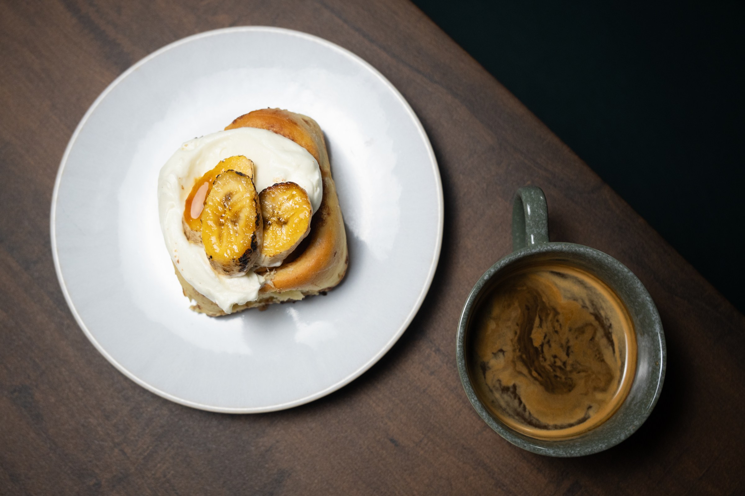 Bananas Foster cinnamon roll and coffee at Sunday Morning.