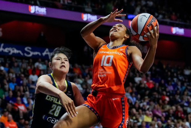 Olivia Nelson-Ododa #10 of the Connecticut Sun shoots against Li Yueru #28 of the Dallas Wings during the first half of a WNBA basketball game at Mohegan Sun Arena on June 20, 2025 in Uncasville, Connecticut. NOTE TO USER: User expressly acknowledges and agrees that, by downloading and or using this Photograph, user is consenting to the terms and conditions of the Getty Images License Agreement. (Photo by Joe Buglewicz/Getty Images)