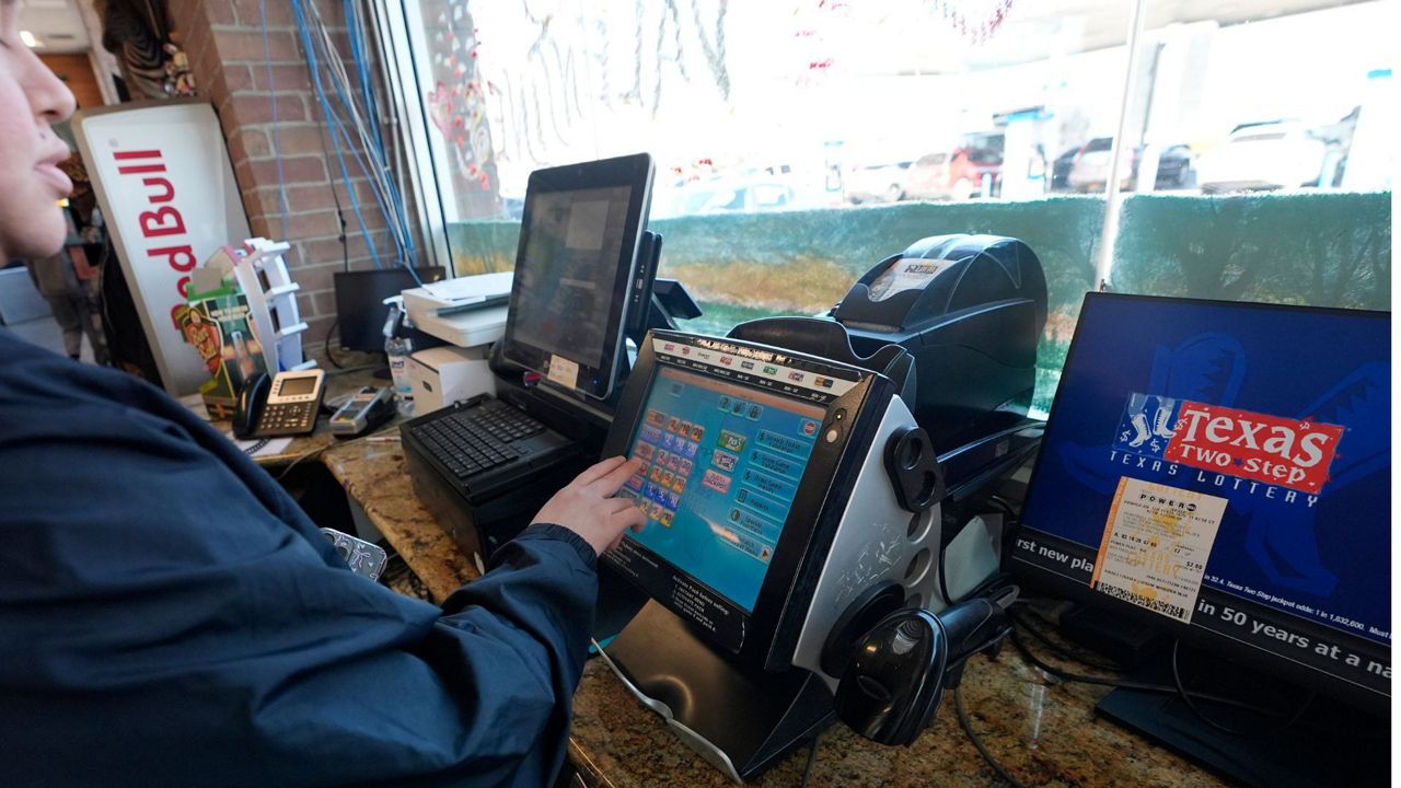 Edith Patlan uses a Texas Lottery terminal to complete at purchase of lottery tickets at Fuel City in Dallas, Wednesday, Feb. 26, 2025. (AP Photo/LM Otero)