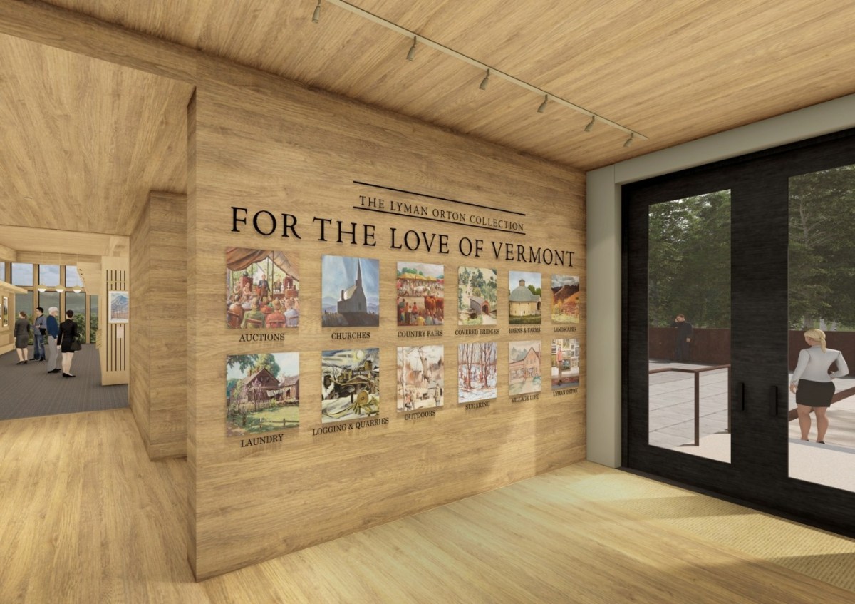 Wood-paneled museum hallway with a display titled "For the Love of Vermont" featuring eight vintage-style posters and people visible through glass doors and windows.