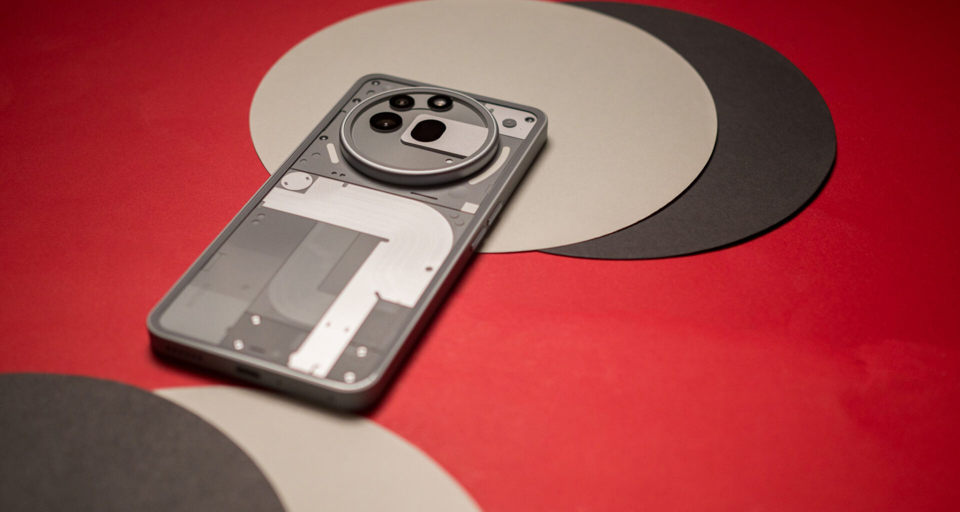 Nothing Phone 3a Pro back view against red background