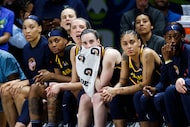 Indiana Fever guard Caitlin Clark (center) watches the second half of a preseason WNBA...