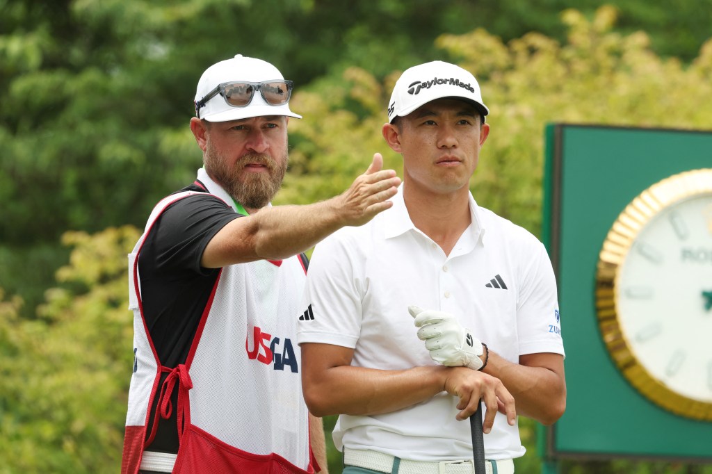 Collin Morikawa and his caddie on the first fairway during the third round of the U.S. Open.