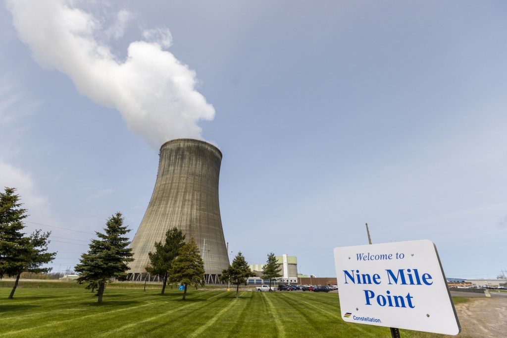 Nine Mile Point nuclear power plant cooling tower with steam rising.