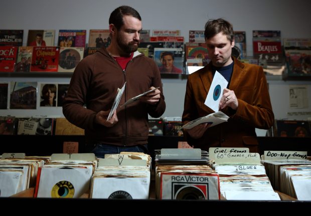 Rob Sevier, left, and Ken Shapley of Numero Group flip through singles at the Record Dug Out in 2013. (E. Jason Wambsgans/Chicago Tribune) 