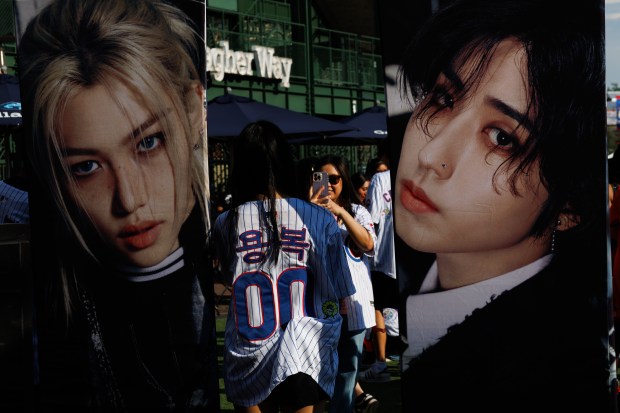 Fans take photos of band members before Stray Kids perform at Wrigley Field, June 26, 2025, in Chicago. (Armando L. Sanchez/Chicago Tribune)