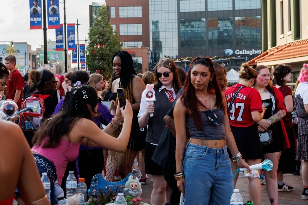 Fans take photos outside Wrigley Field before Stray Kids perform, June 26, 2025, in Chicago. (Armando L. Sanchez/Chicago Tribune)