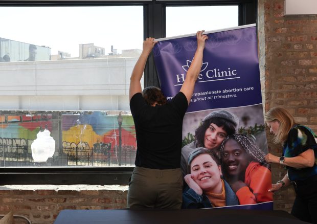 Clinic owner Julie Burkhart, right, and a staff member put together signage at Hope Clinic in Chicago on May 6, 2025. (Stacey Wescott/Chicago Tribune)