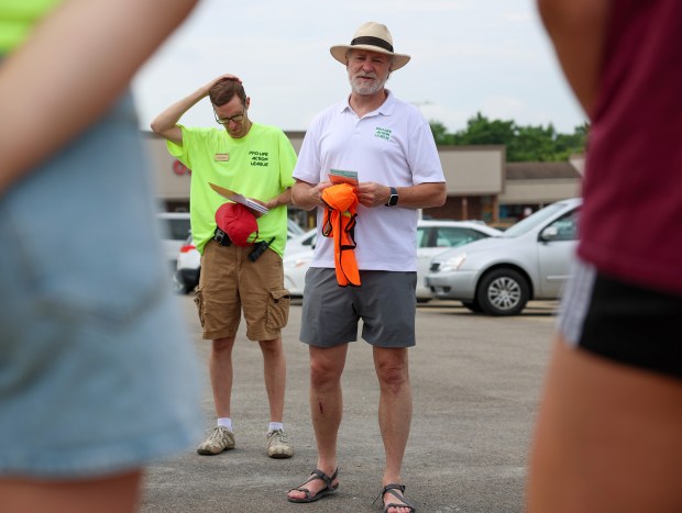 Eric Scheidler, executive director of the Chicago-based Pro-Life Action League, center, speaks with activists after their Face the Truth Tour stop near Rand Road and Illinois Route 22 on June 18, 2025, in Lake Zurich. (Stacey Wescott/Chicago Tribune)