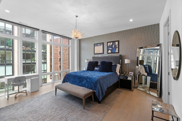 The condo at 2773 Hampden Court, Unit PH03, in Lincoln Park, has a rooftop deck with an outdoor kitchen and murals on two of the terrace walls. (Kurt Cichowski)