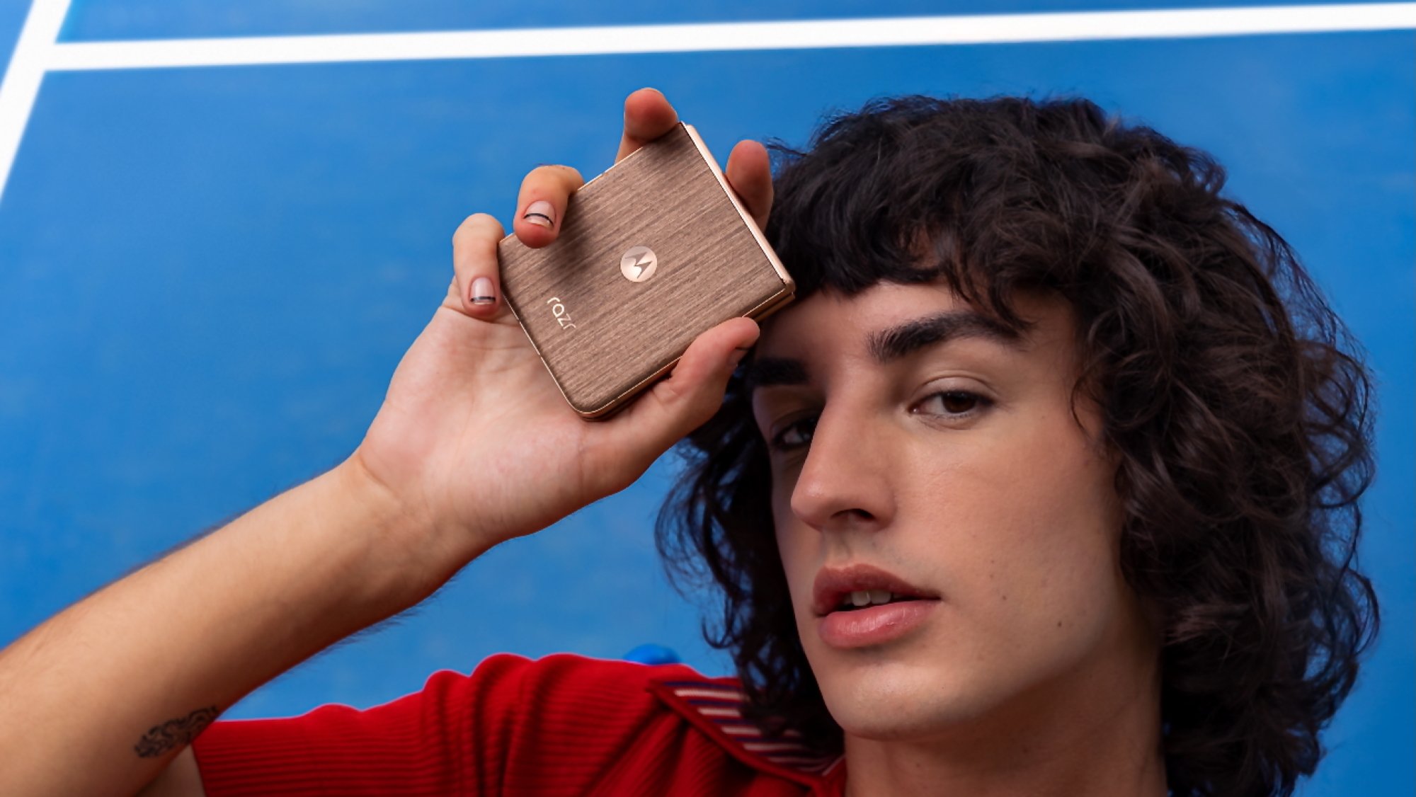 male model holding motorola razr ultra with wood finish