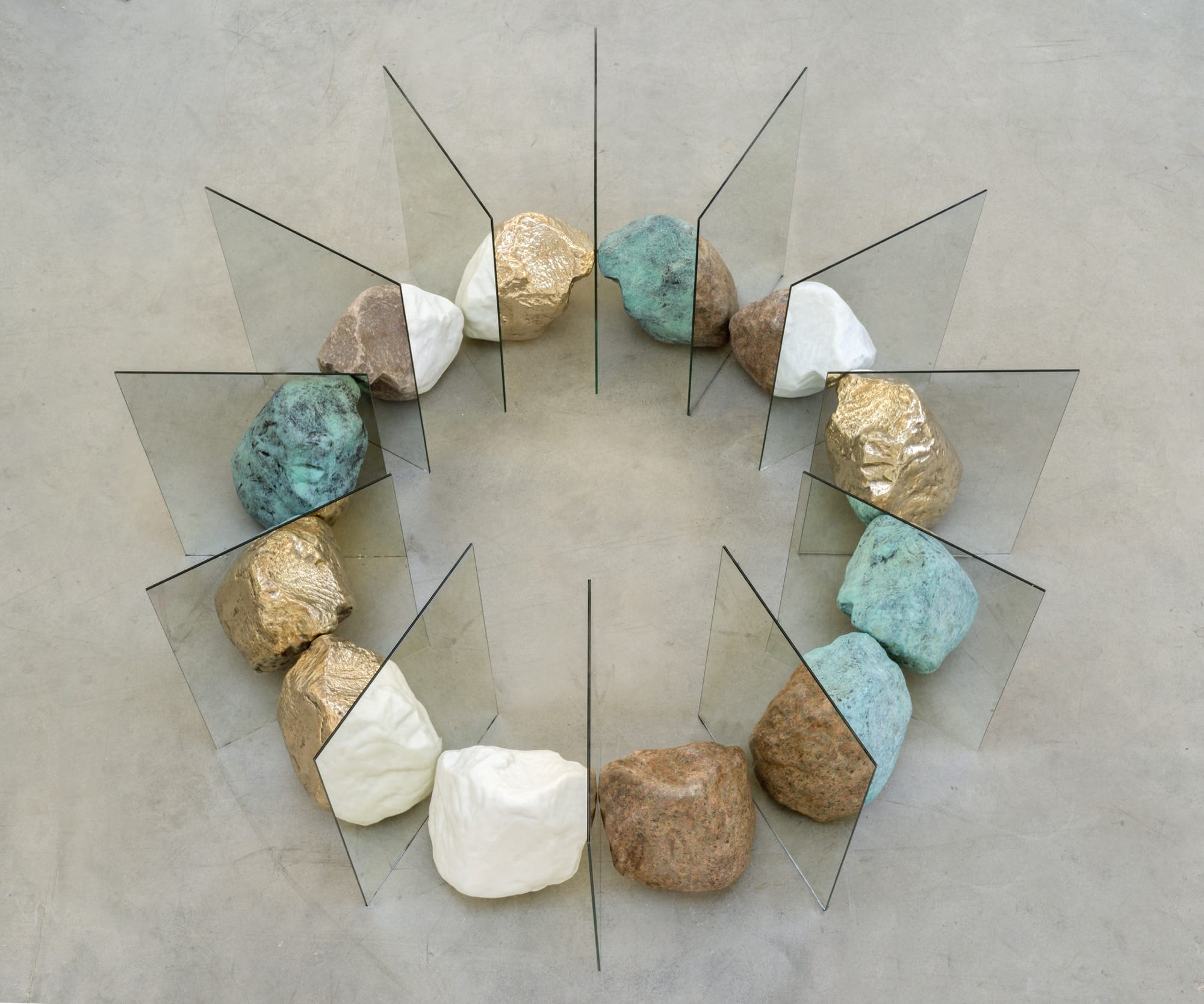 colorful stones arranged in a circle with mirrors slotted between them