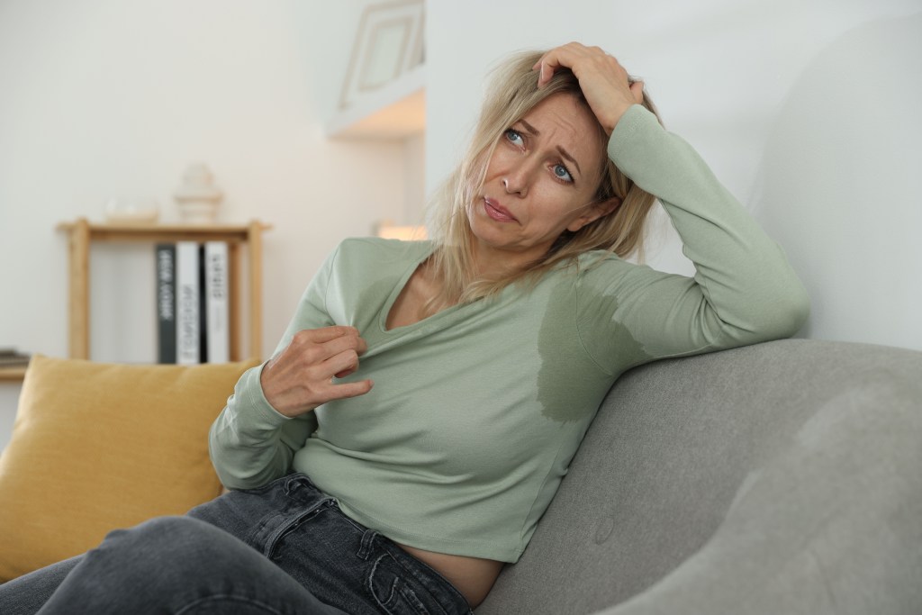 Woman experiencing hot flash symptoms.