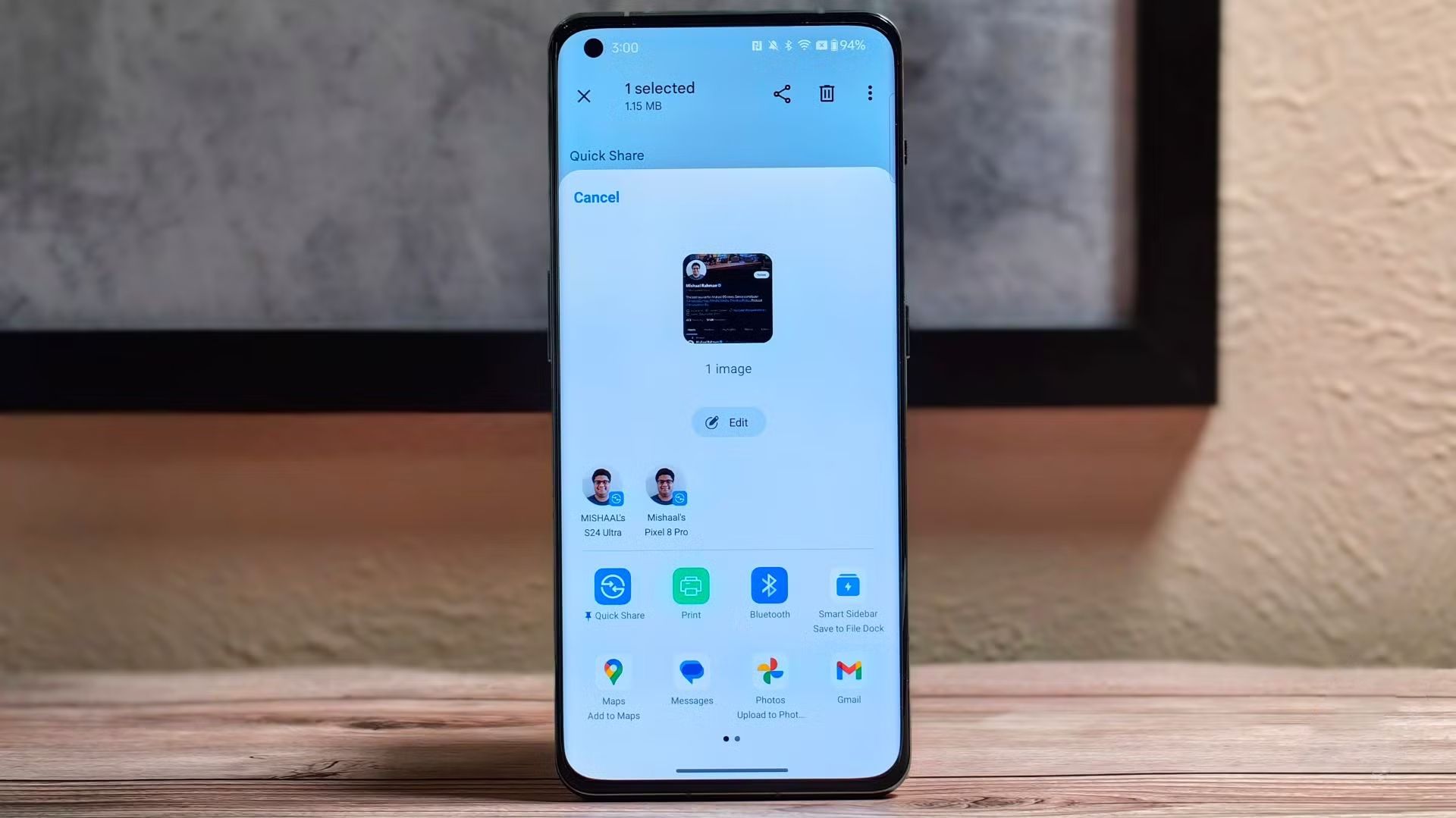 The Android Quick Share menu open on a phone standing upright on a table.