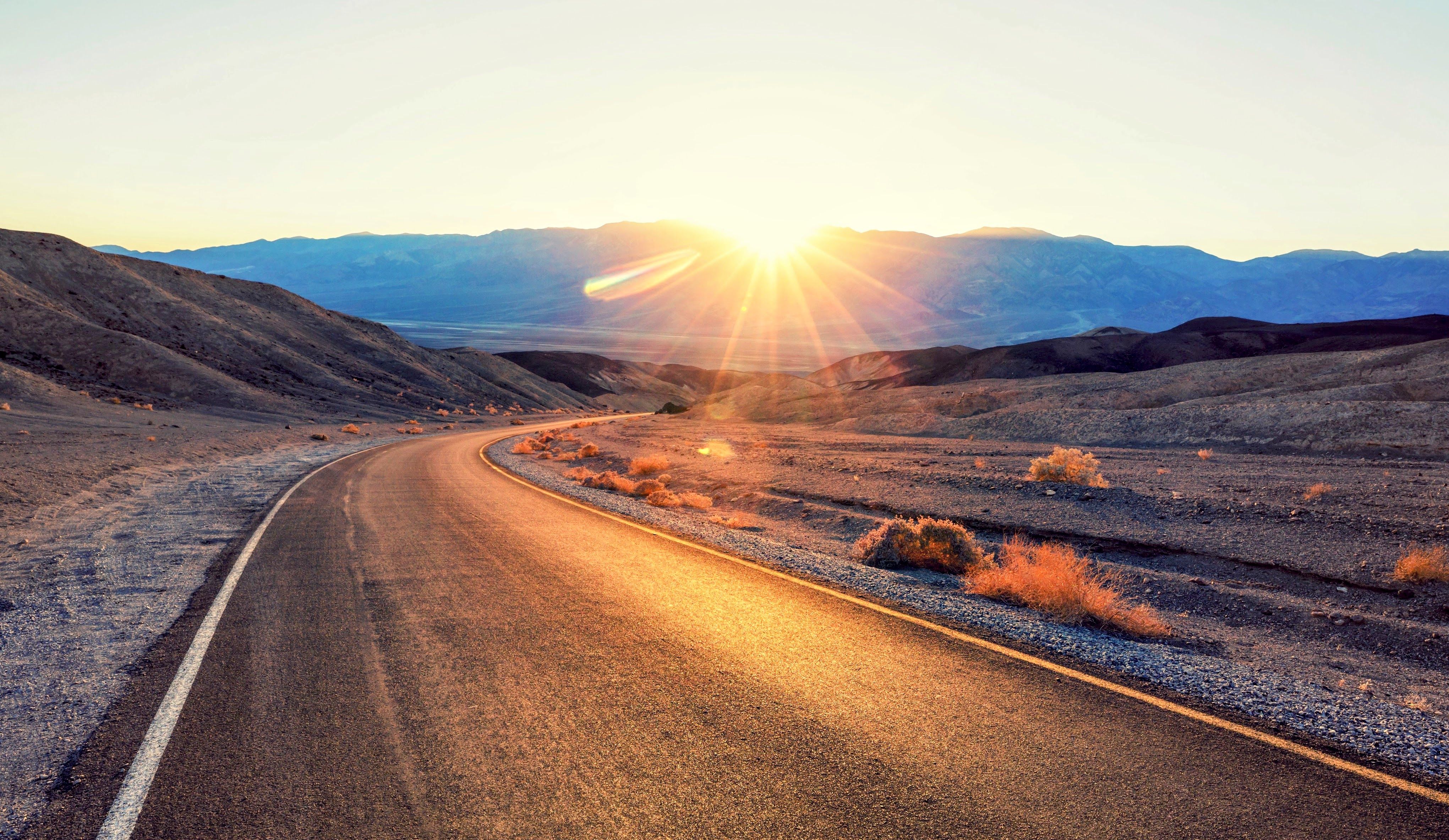 Low sun setting over an asphalt road in Death Valley National Park, California/Nevada, USA