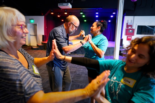 At The Chrysalis: Monarch Center for the Arts in San Diego, Calif., on Saturday, June 7, 2025, 72-year-old Ron Weidner worked with his physical therapist, Rosalia Arellano, on hand and foot dance movement. Weidner, a former home painting contractor, retired after later being diagnosed with Parkinson's disease. (Nelvin C. Cepeda / The San Diego Union-Tribune)