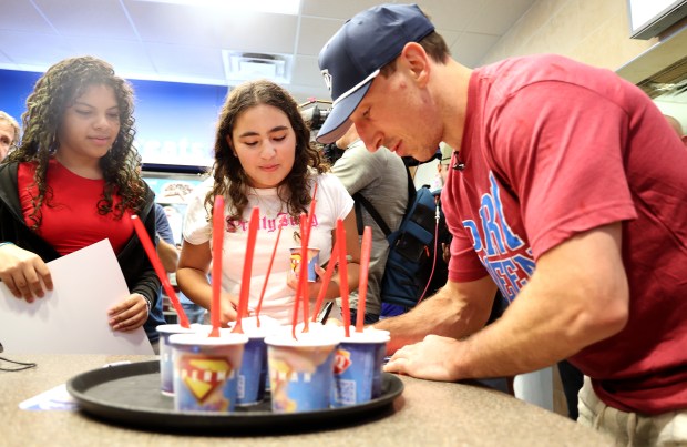 Panthers star Brad Marchand signs autographs for Madisson Munez, left,...