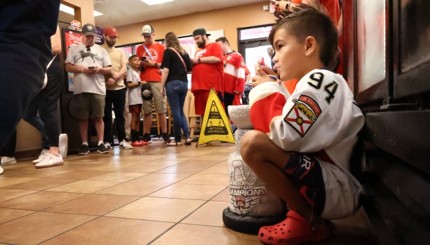 Panthers fan, Alex James, 9, of Plantation, eats a blizzard...