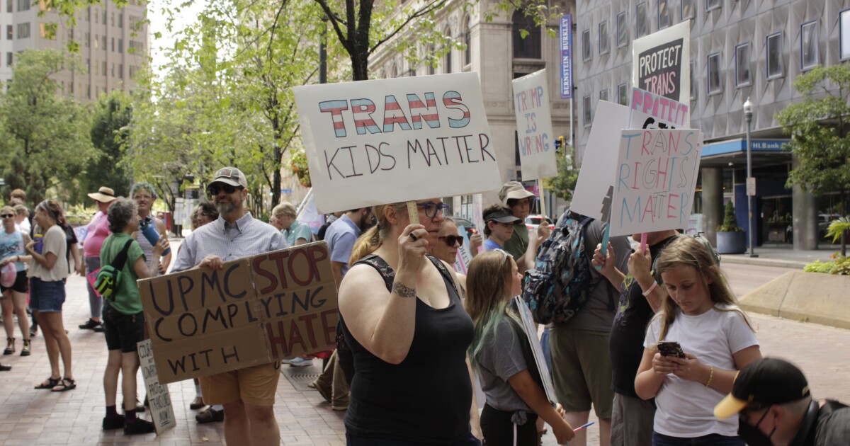 Advocates rally in support of trans health care in front of UPMC building 