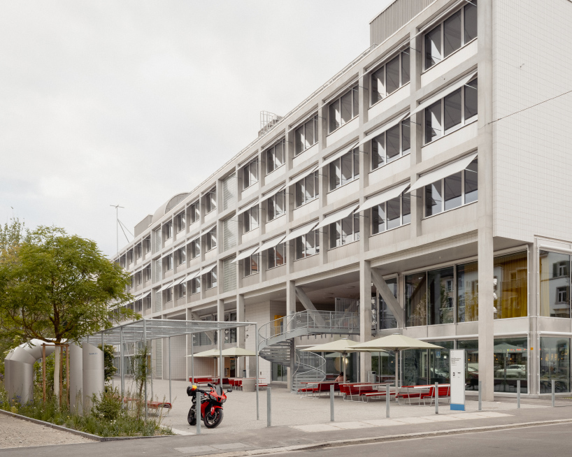elevated concrete truss frame forms vocational school for construction trades in zurich