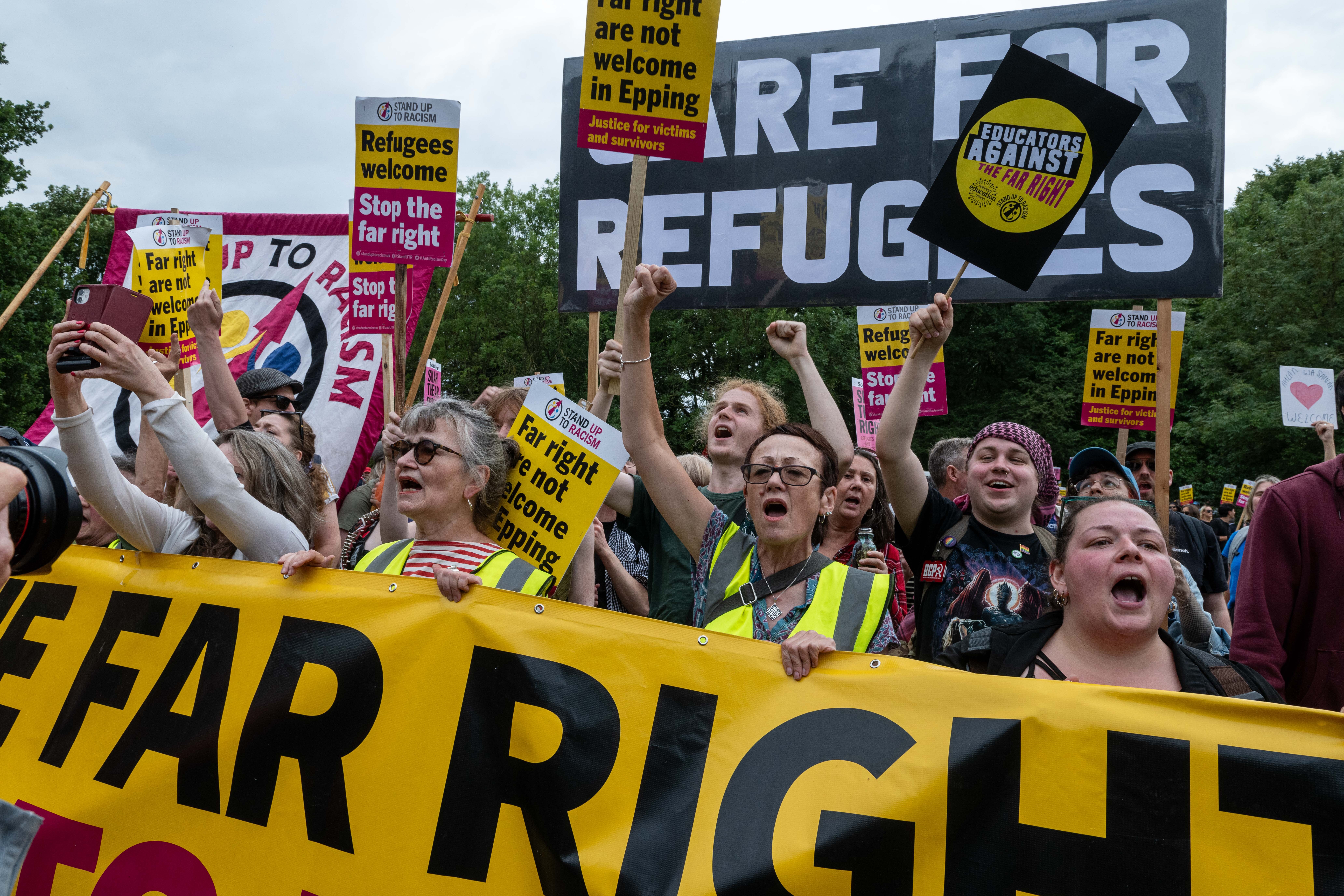 Counter-protestors in Epping, UK, rally in support of asylum seekers.