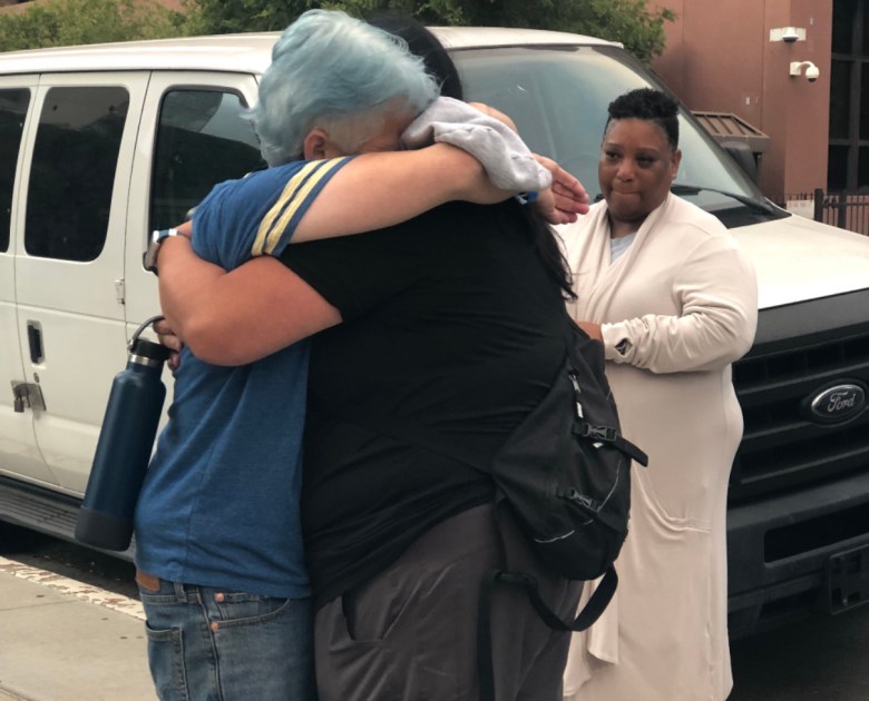 Two women embracing.
