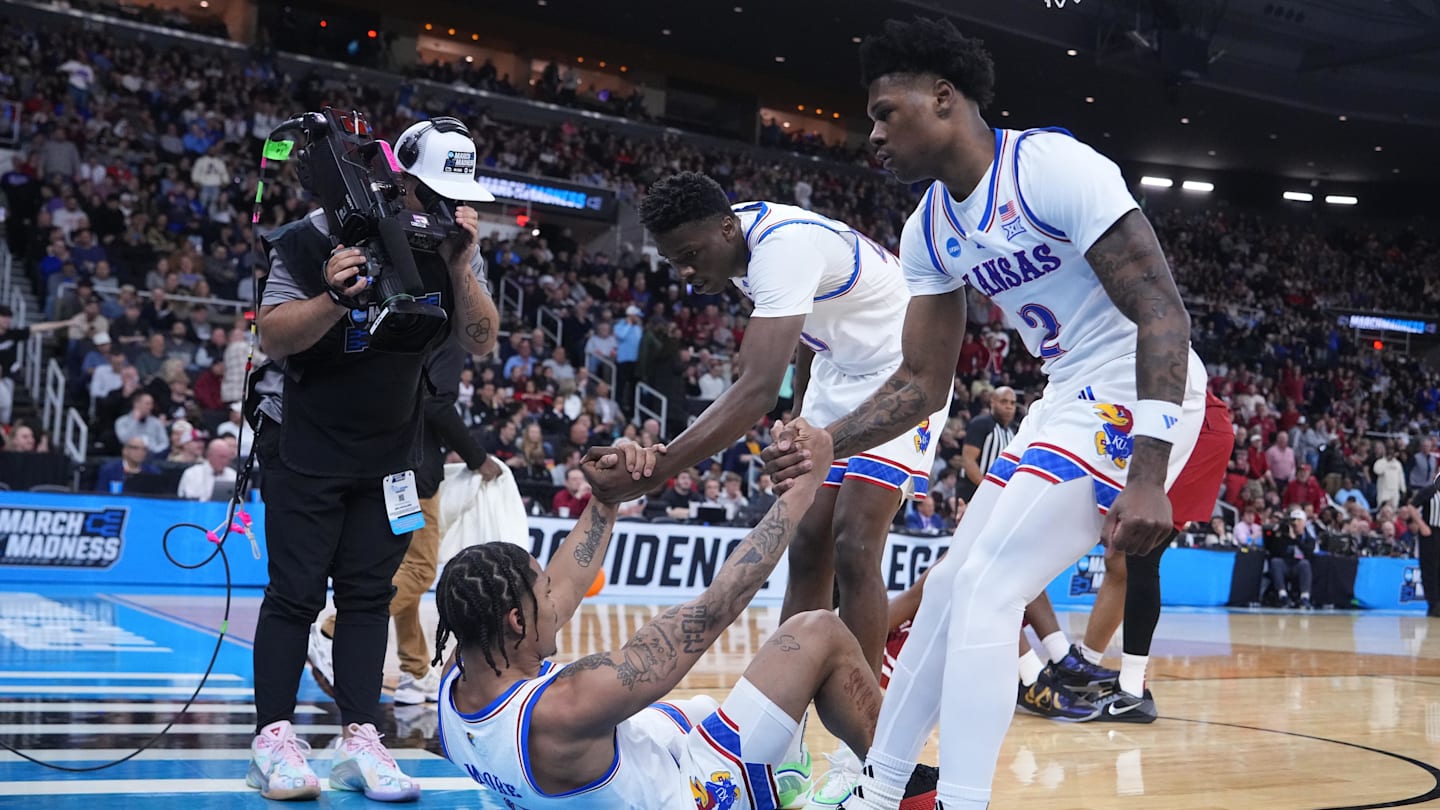 Mar 20, 2025; Providence, RI, USA;  Kansas Jayhawks guard Shakeel Moore (0) is helped up during the first half against Arkansas Razorbacks at Amica Mutual Pavilion. Mandatory Credit: Gregory Fisher-Imagn Images