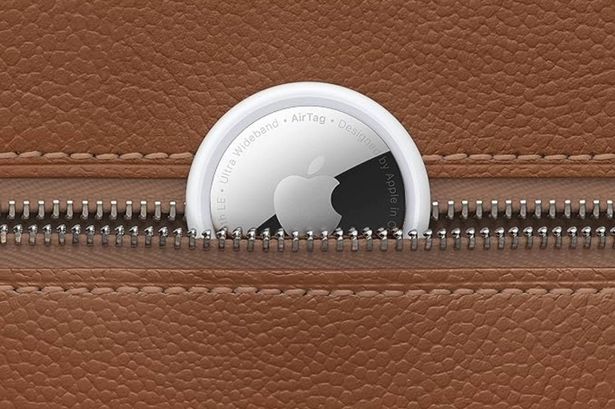 Apple AirTag pictured in a brown wallet