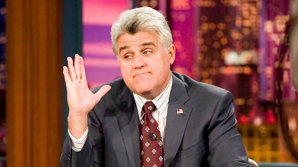 jay leno on the tonight show raising his hand