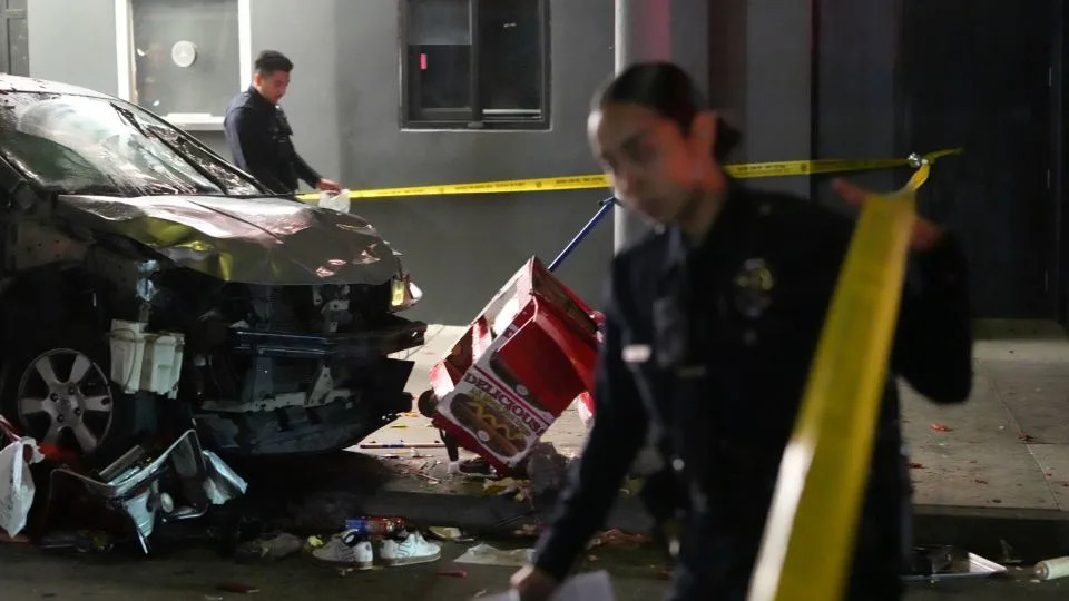 Law enforcement investigated the scene where a vehicle rammed into a crowd of people waiting to enter a nightclub along a busy boulevard in Los Angeles early Saturday. - Damian Dovarganes/AP