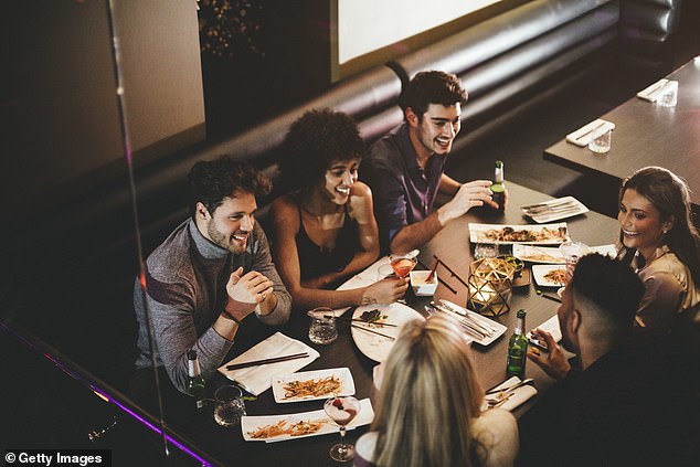 A file photo of a group of friends enjoying a meal on a night out