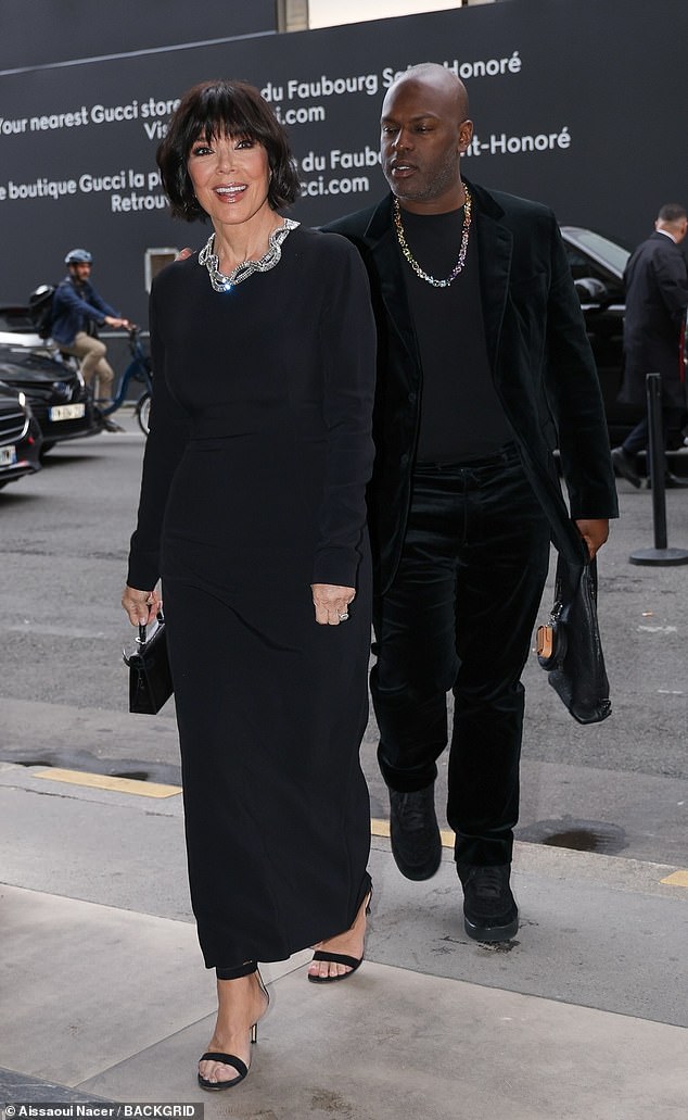 Jenner slipped into a snug-fitting, long-sleeved black dress with a stone-embellished statement collar