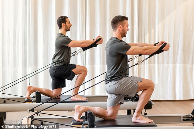 A growing number of men are incorporating Pilates into their fitness routines. Many report looking taller as a result of their improved posture (stock images)