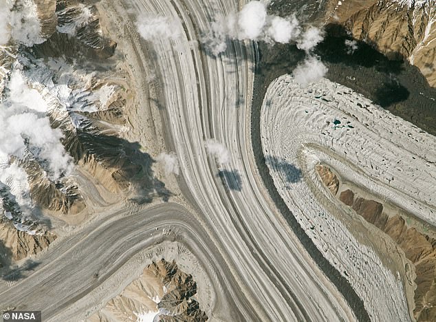 The photo revealed how a huge moraine (dark-colored band on the right) of trapped dust and rock has been wedged between the Siachen and Teram Shehr glaciers