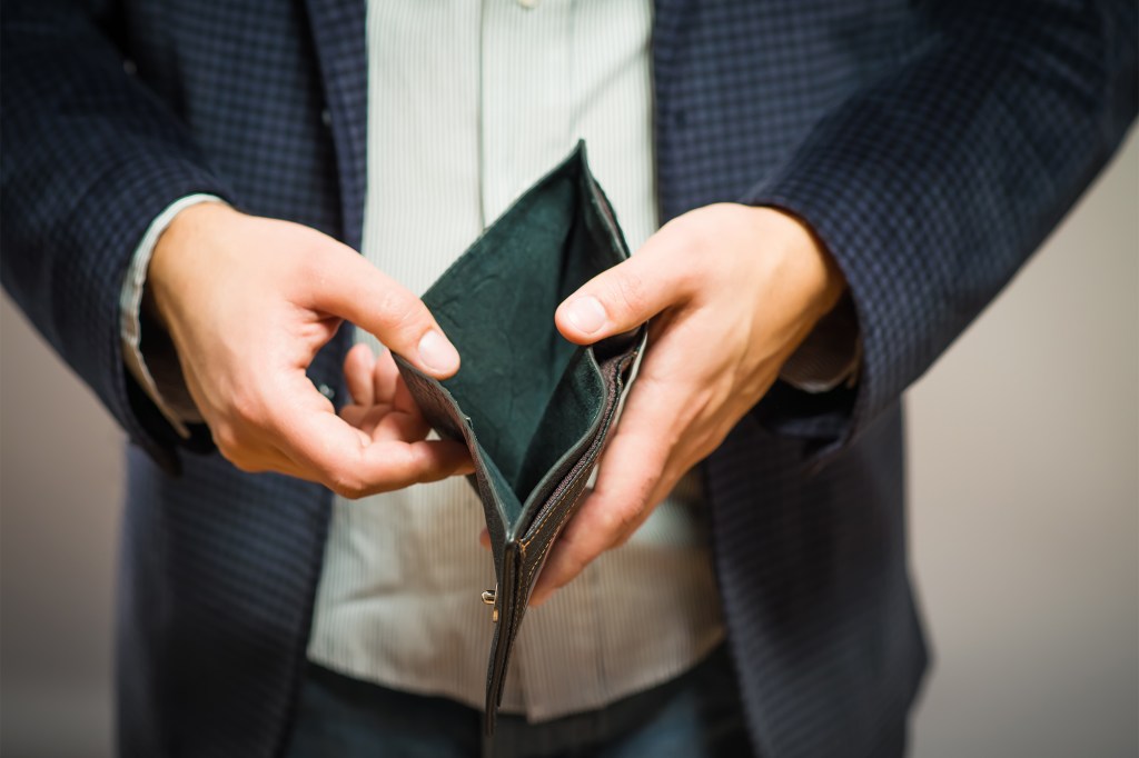 Person showing an empty wallet.