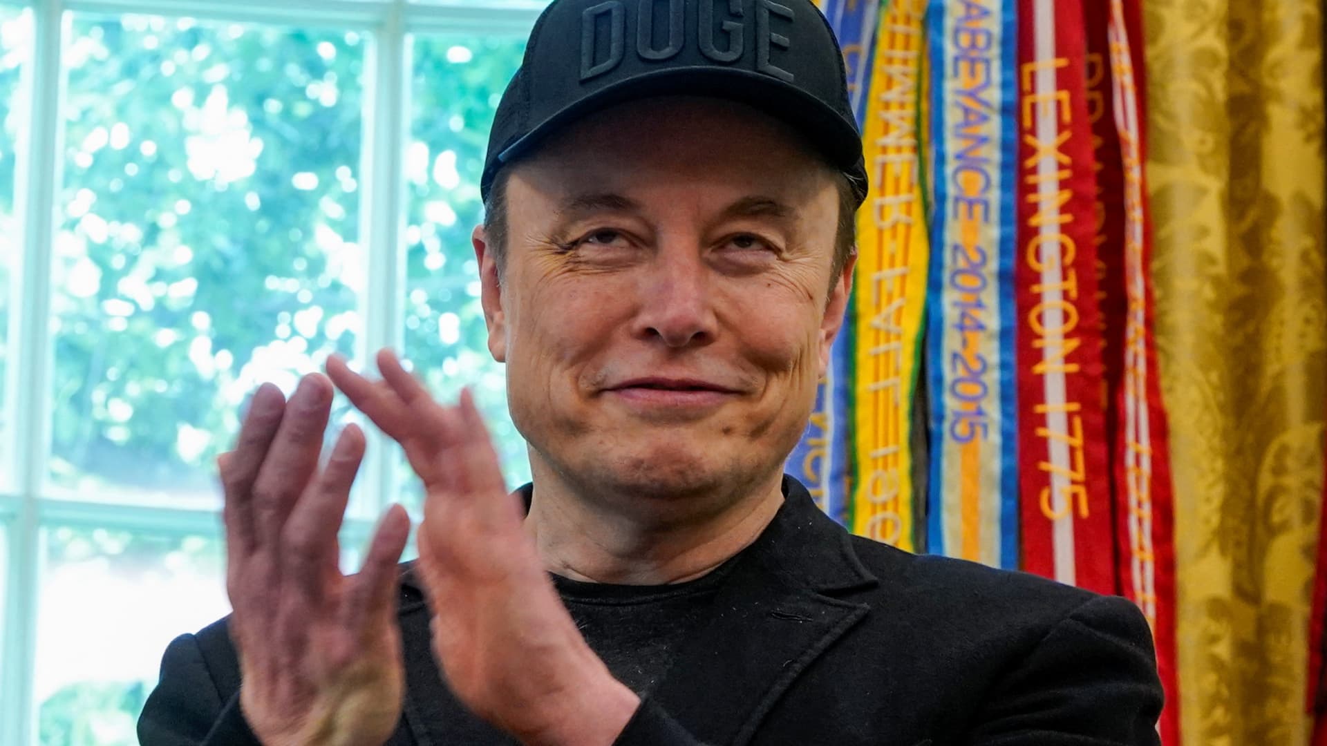 Elon Musk applaudes in the Oval Office as he attends a press event with U.S. President Donald Trump, at the White House in Washington, D.C., U.S., May 30, 2025.