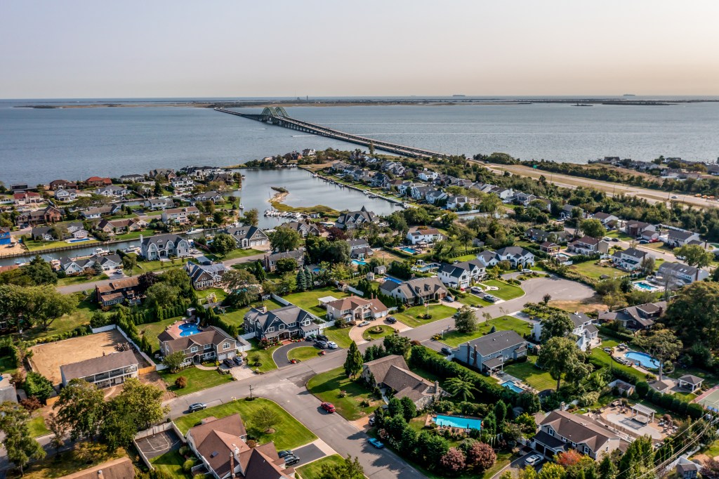 Aerial view of Long Island, New York, showing houses, waterways, and the Robert Moses Causeway.