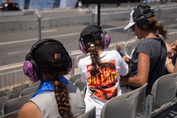 From left, Quinn McRae, 12, Emma McRae, 10 and Melissa McRae watch the Nascar Infinity Series Practice & Qualifying ahead of the NASCAR Xfinity Series The Loop 110 on Saturday, July 5, 2025. (Audrey RIchardson/Chicago Tribune)