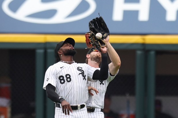 Chicago White Sox outfielders Luis Robert Jr. (88) and Austin Slater (15) interfere with each other trying to catch a pop-up in the second inning against the Cleveland Guardians at Rate Field on Sunday, July 13, 2025. (Eileen T. Meslar/Chicago Tribune)