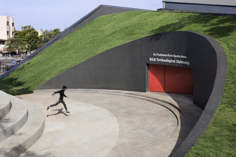 this sports arena is both ground and sky a structure that disappears into landscape yet commands the citys attention boldly 6
