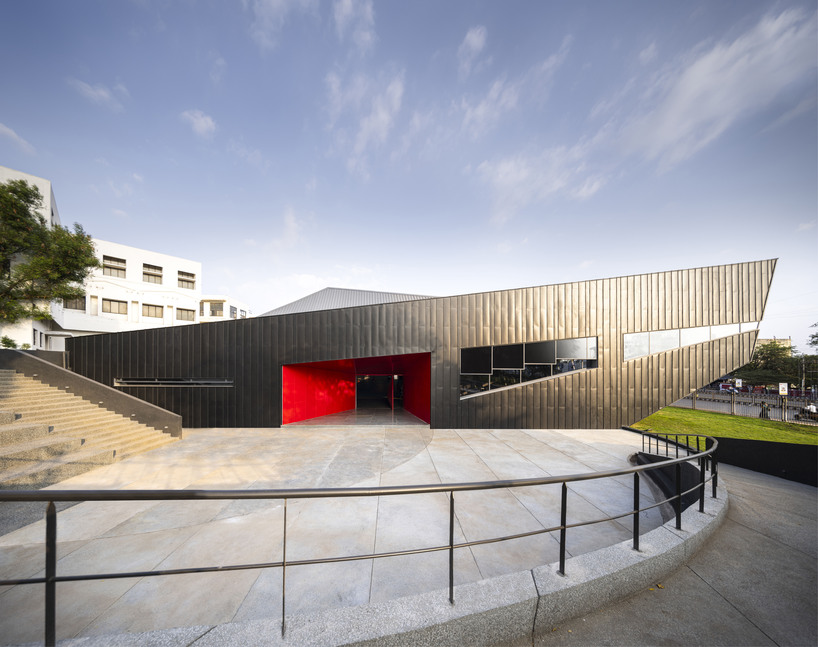 this sports arena is both ground and sky a structure that disappears into landscape yet commands the citys attention boldly 7
