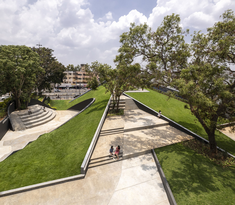 this sports arena is both ground and sky a structure that disappears into landscape yet commands the citys attention boldly 5