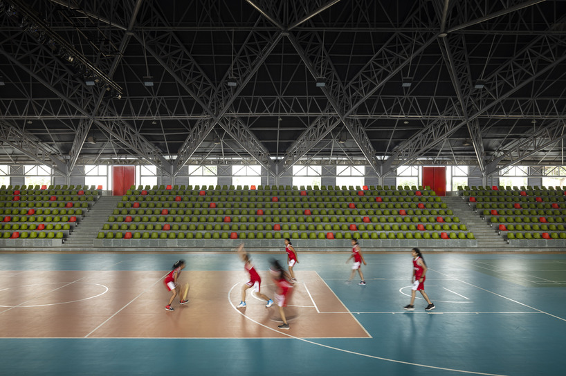 this sports arena is both ground and sky a structure that disappears into landscape yet commands the citys attention boldly 1