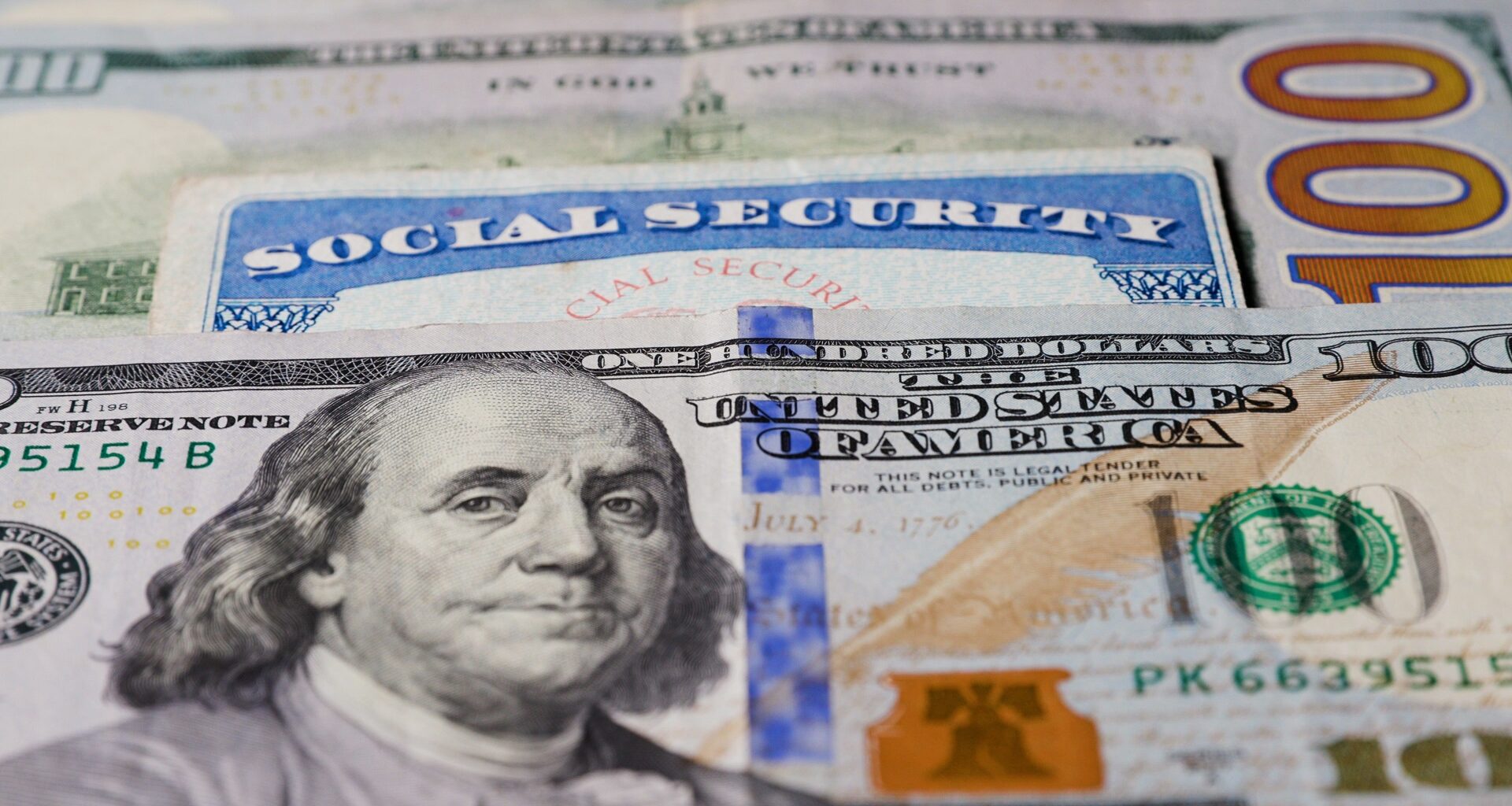 Photo of social security card with one hundred dollar bills.