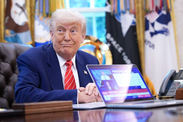 WASHINGTON, DC - MAY 30: U.S. President Donald Trump, joined by Tesla CEO Elon Musk, shows a news video from a laptop in the Oval Office of the White House on May 30, 2025 in Washington, DC. Musk, who served as an adviser to Trump and led the Department of Government Efficiency, announced he would leave his role in the Trump administration early this week to refocus on his businesses. (Photo by Kevin Dietsch/Getty Images)